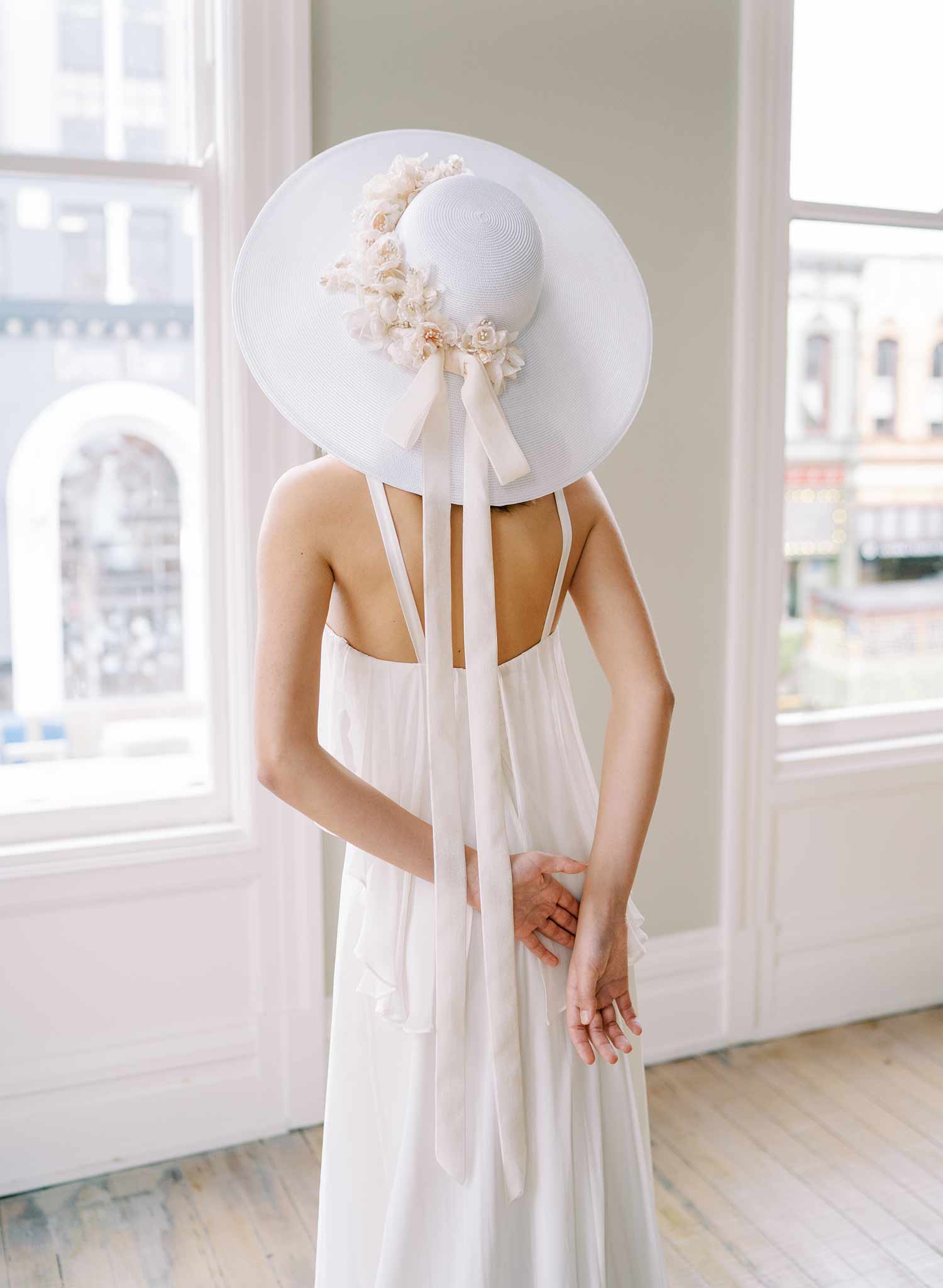 wide white straw hat with silk flowers and bow, twigs and honey