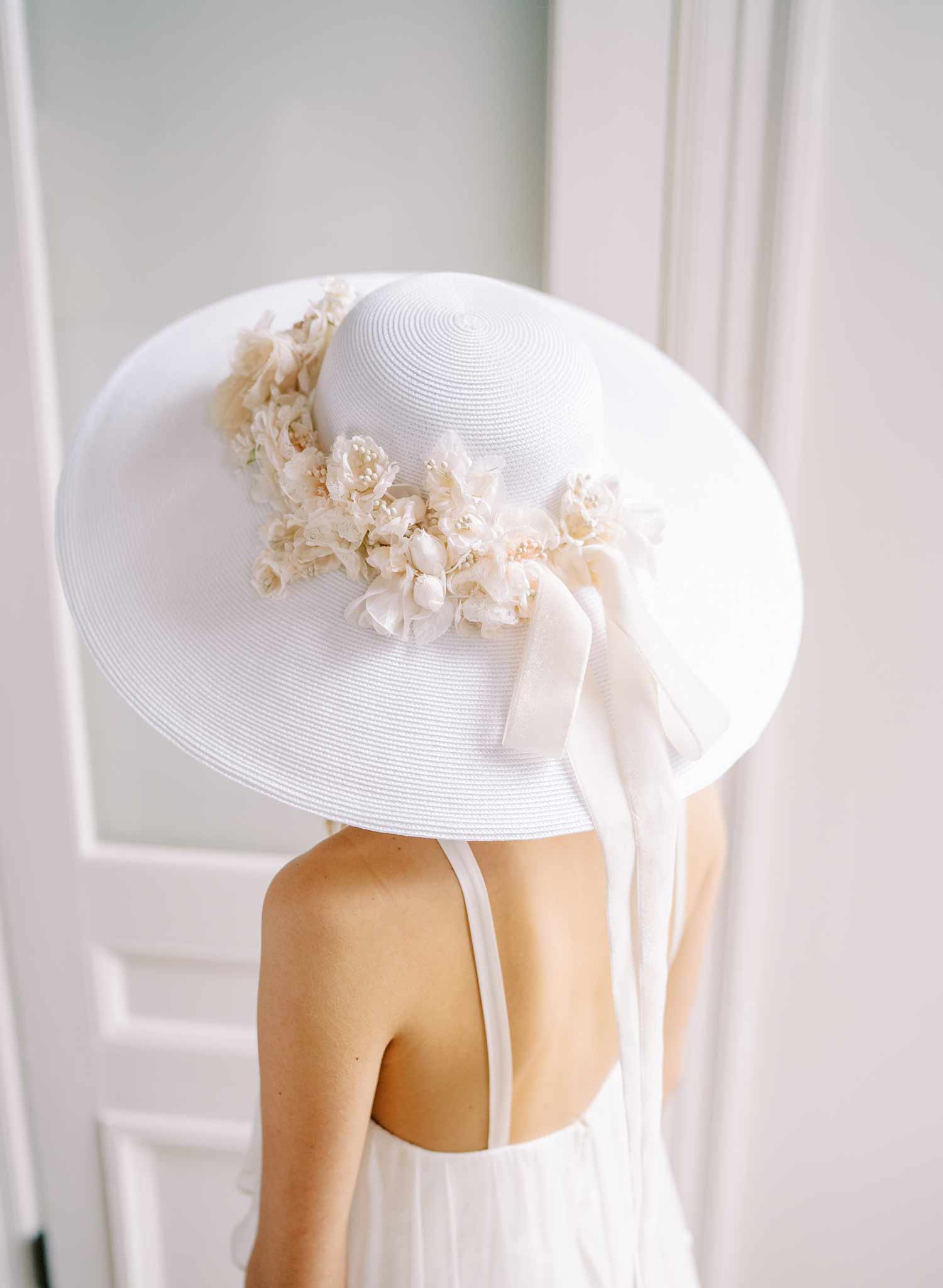 wide white straw hat with silk flowers and bow, twigs and honey