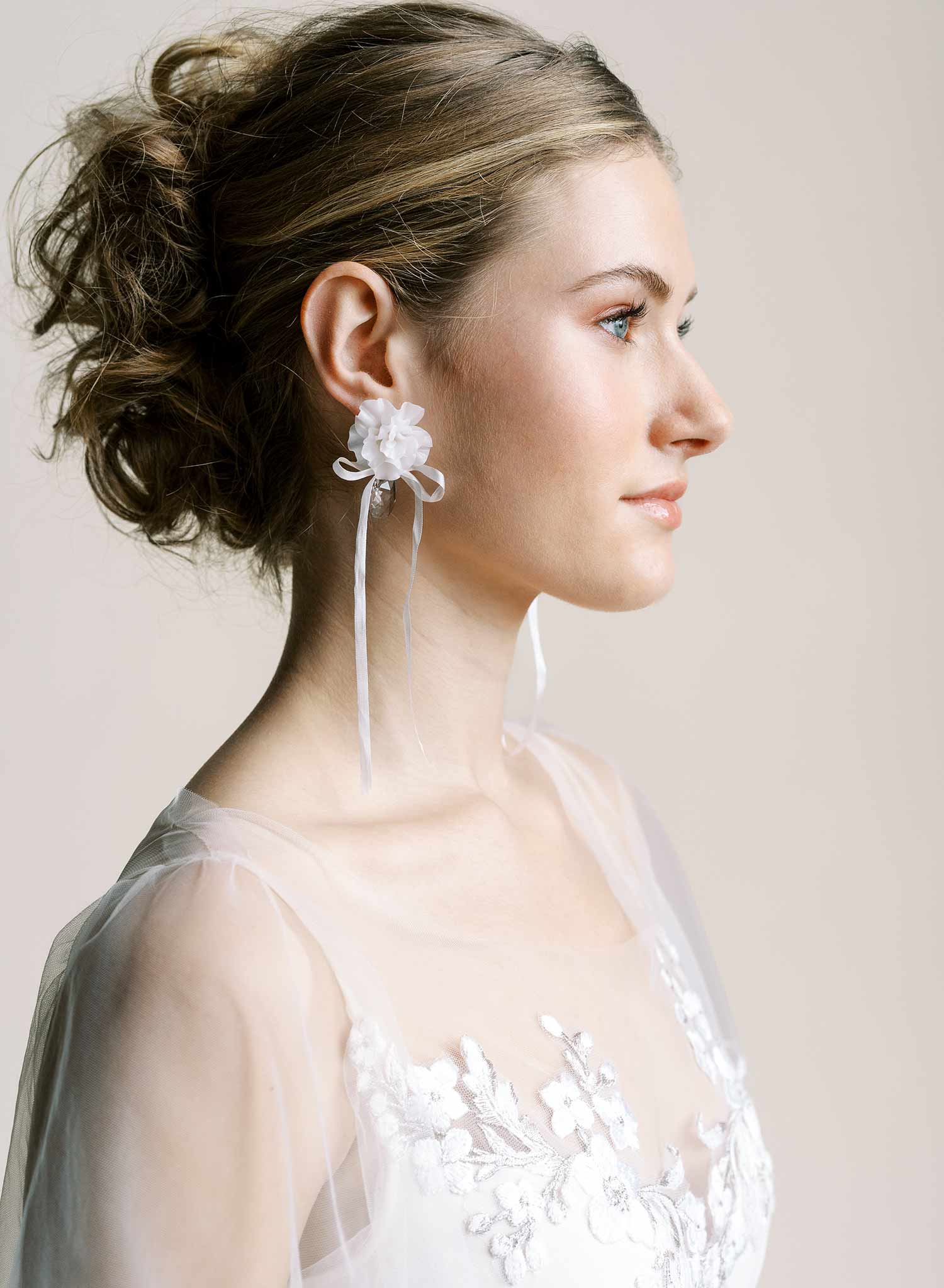 Clean white hand sculpted bridal flower earrings with teardrop clear crystal and silk bows. Wedding earrings by Twigs and Honey