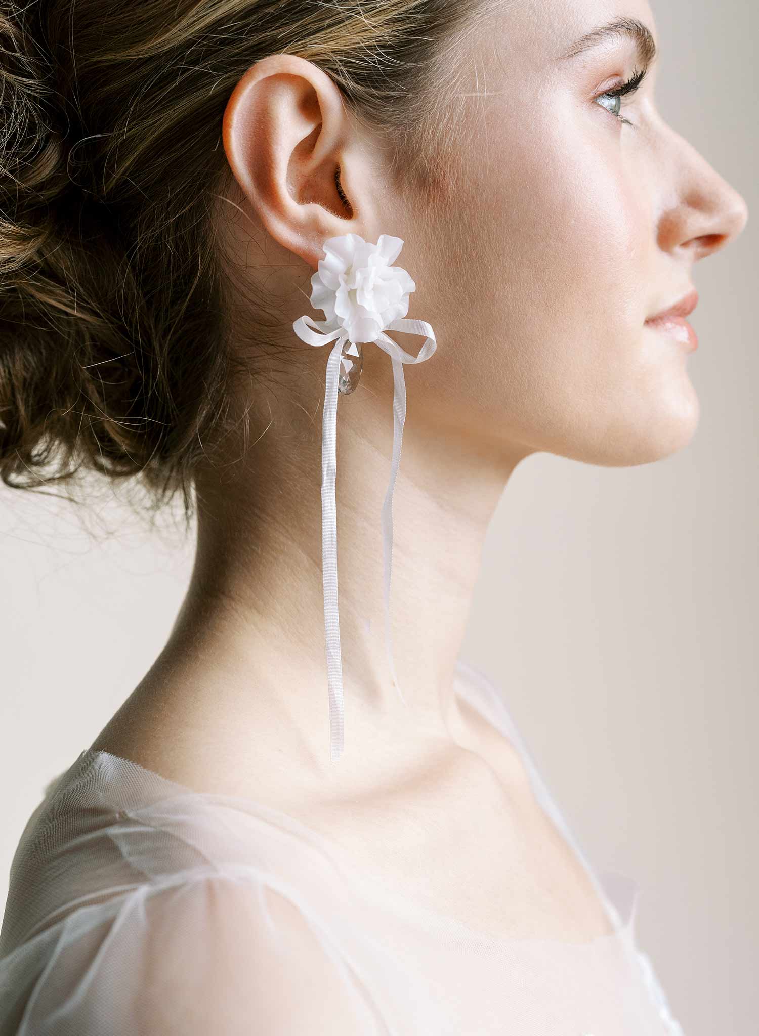 Clean white hand sculpted bridal flower earrings with teardrop clear crystal and silk bows. Wedding earrings by Twigs and Honey