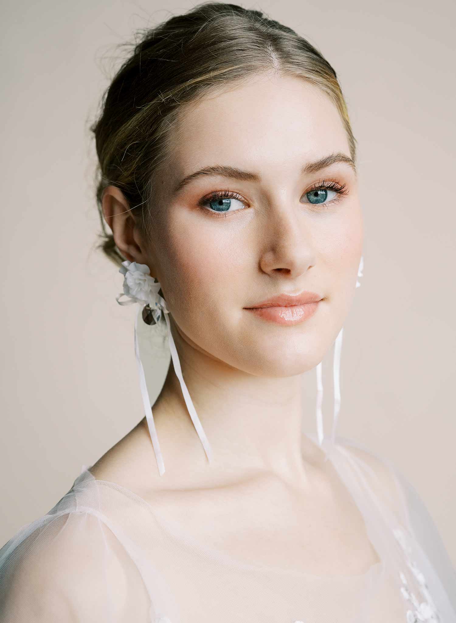 Clean white hand sculpted bridal flower earrings with teardrop clear crystal and silk bows. Wedding earrings by Twigs and Honey