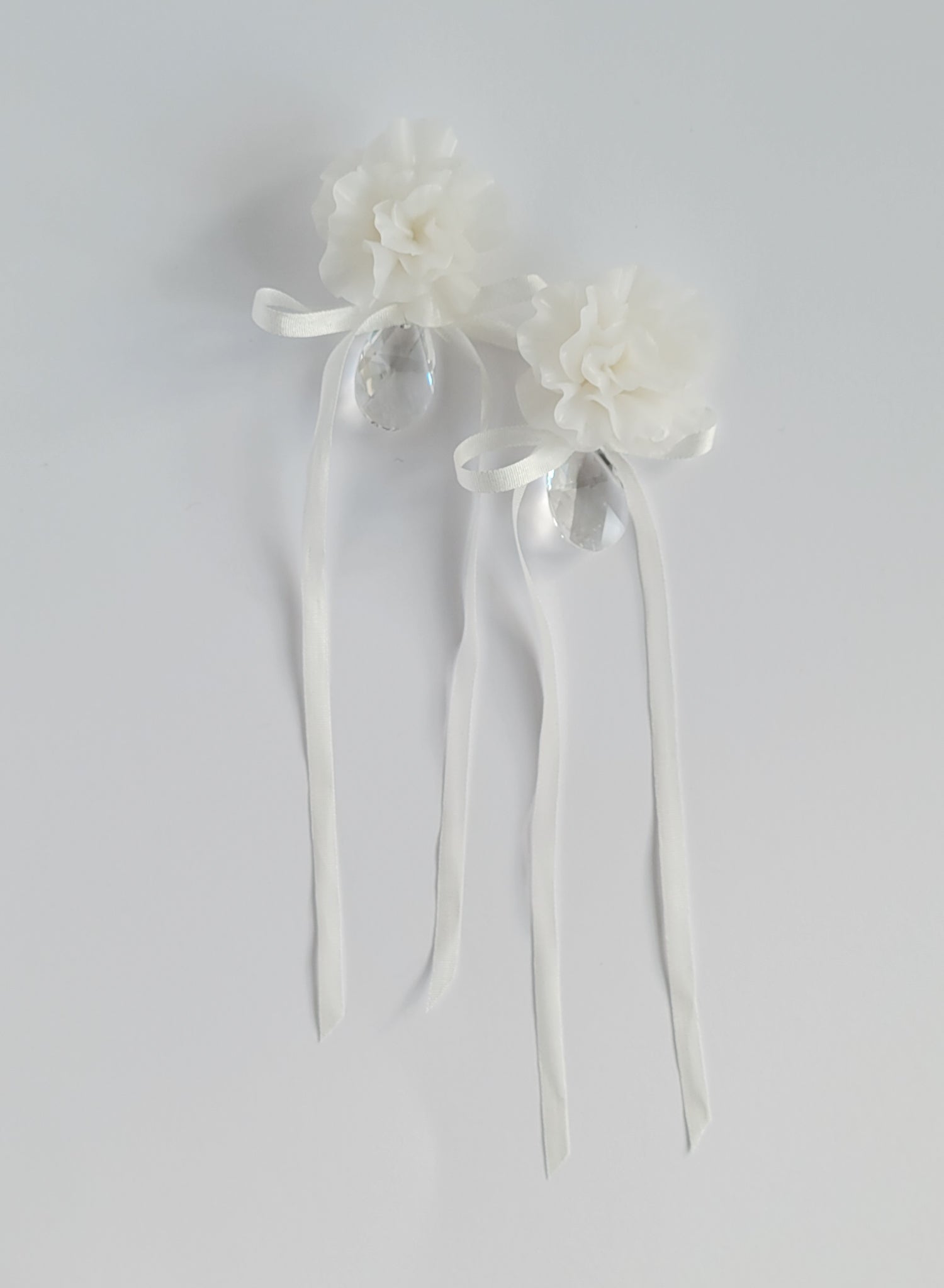 Clean white hand sculpted bridal flower earrings with teardrop clear crystal and silk bows. Wedding earrings by Twigs and Honey