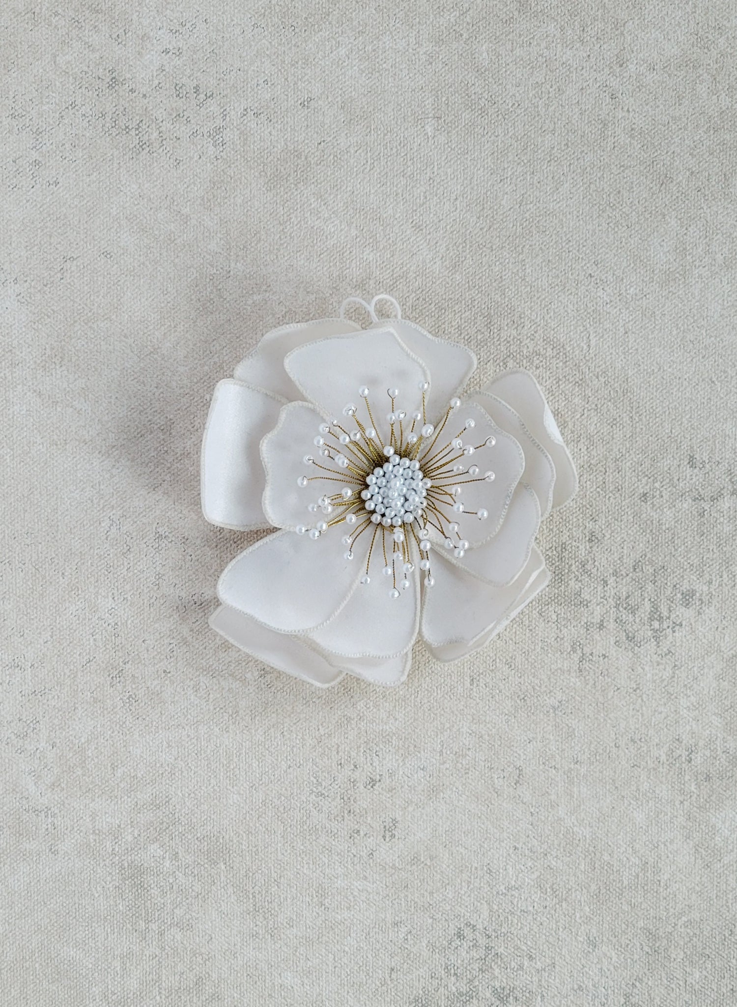 Hand embroidered wedding hair flower on a comb by Twigs and honey