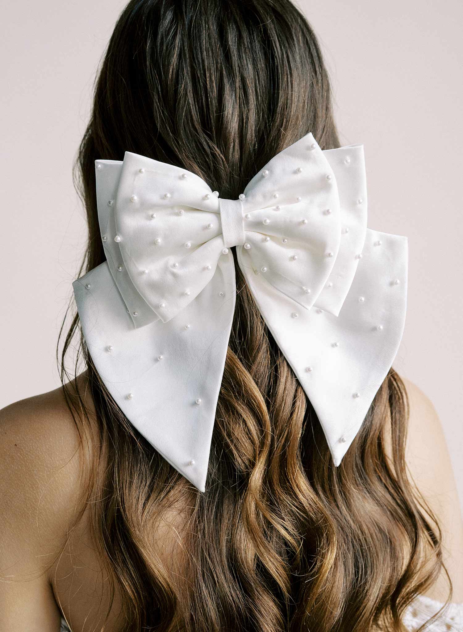 Handmade bridal hair bow with pearl beads by Twigs and Honey.